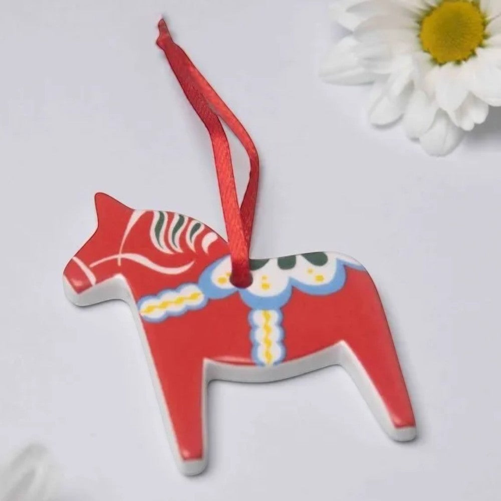 aelgmark red ceramic Dala horse ornament with painted details and red ribbon.