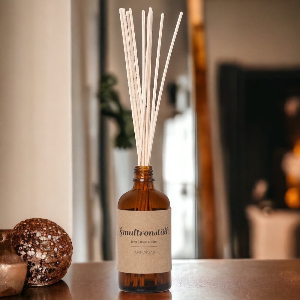 aelgmark Nordic Seasons Secret Forest reed diffuser with amber glass bottle and natural reeds. Notes of freesia, honey, and peony.