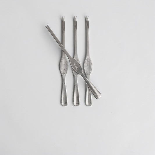 aelgmark Sivan 4-piece stainless steel seafood fork set with elegant ribbed handles and a subtle engraved initial.