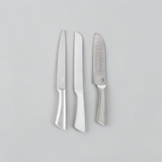 aelgmark three-piece stainless steel kitchen knife set: bread knife, Santoku knife with air pockets, and carving knife. Marble background.