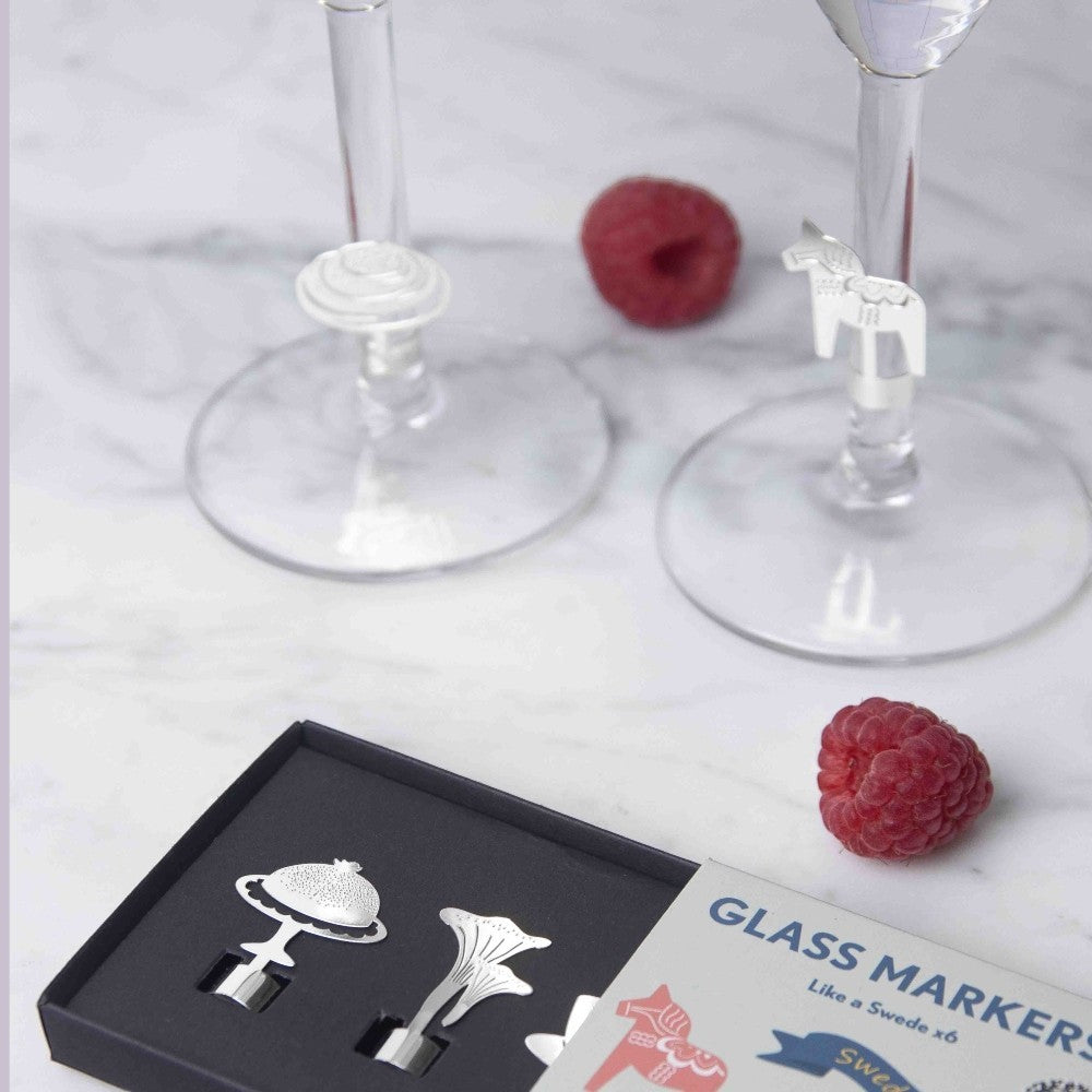 aelgmark set of 6 silver metal glass markers with Swedish cultural motifs like a Dala horse and mushroom for wine glasses.