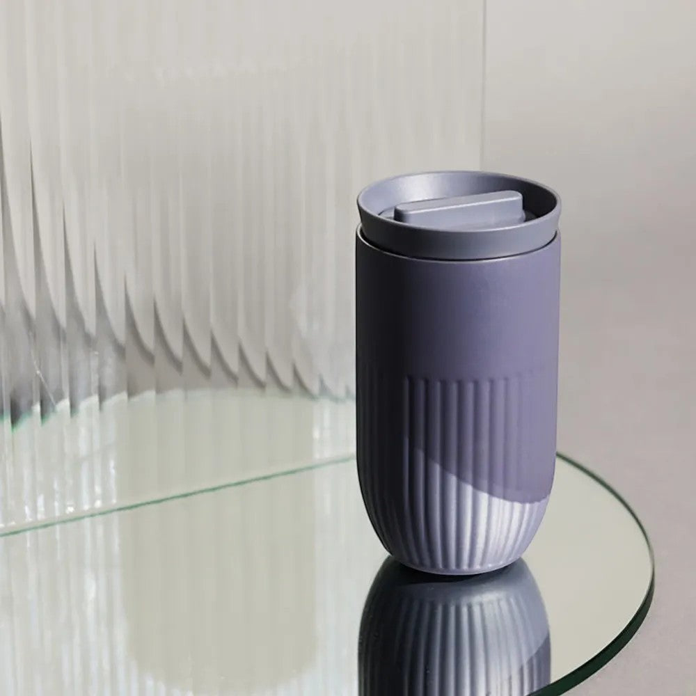 aelgmark Tova purple ceramic travel mug with ribbed texture and press-top lid, 360-degree drinking.