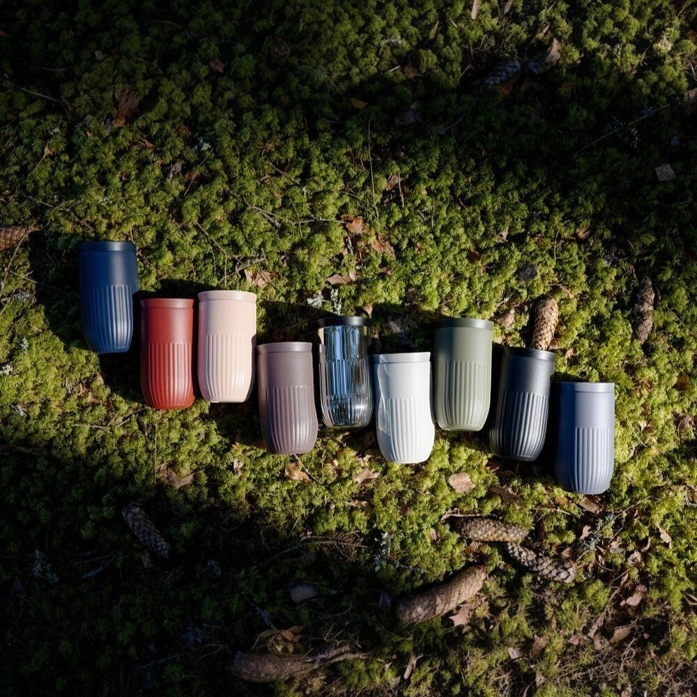 aelgmark Tova travel mugs in navy, rust, beige, taupe, clear, white, olive green, and charcoal. Ribbed design, 360-degree drinking.