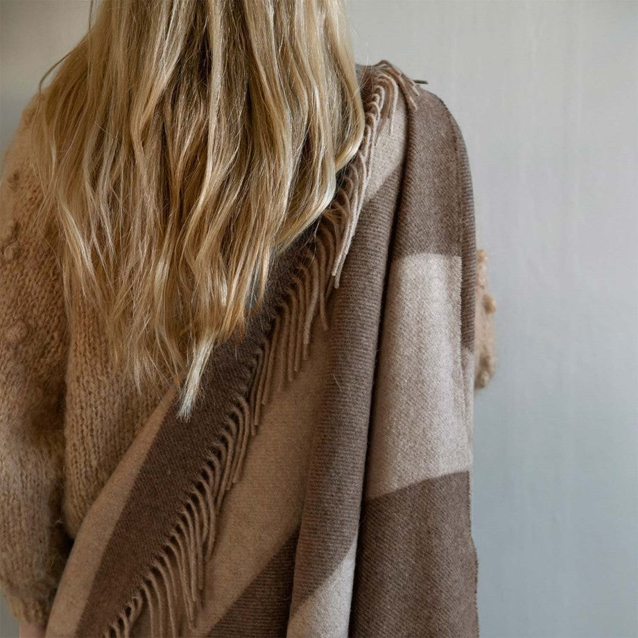 aelgmark Ulle wool throw blanket in brown and beige stripes with fringe detail. Luxurious merino wool for cozy home decor.
