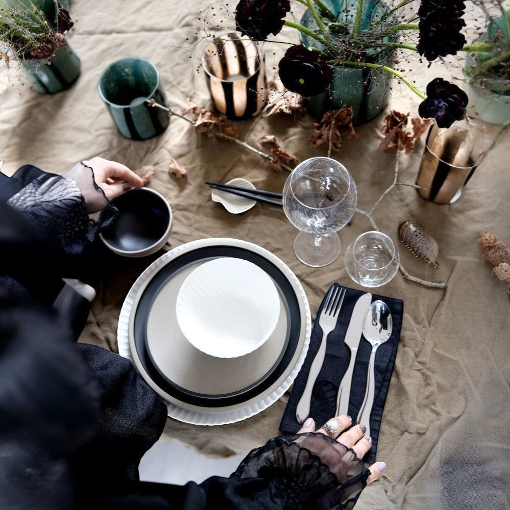 aelgmark Waverly 16-piece stainless steel cutlery set with wave-inspired design, including forks, knives, and spoons.