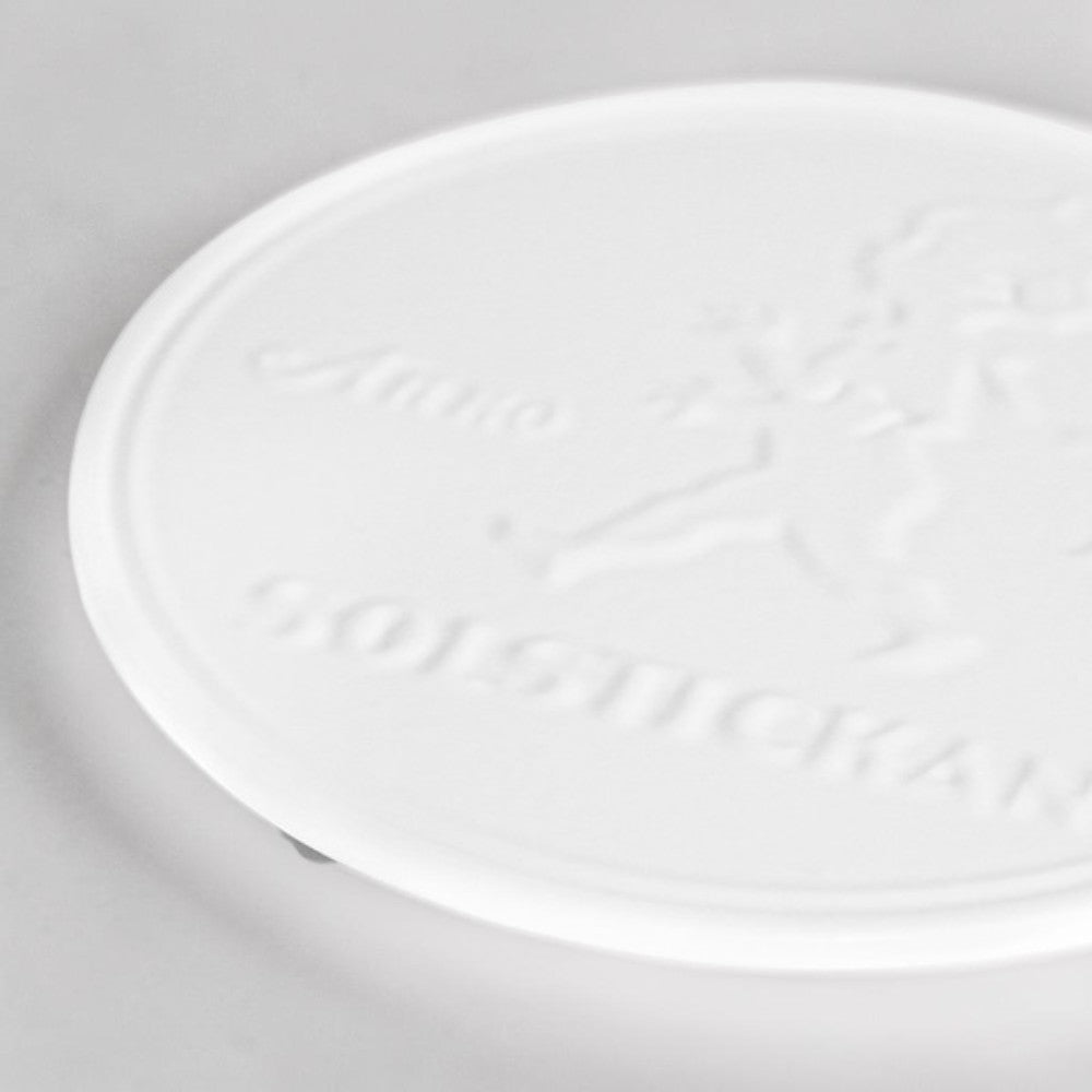 aelgmark white embossed cast iron trivet with SOLSTICKAN logo and boy motif
