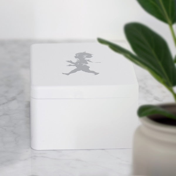 Aelgmark white metal storage tin with a grey silhouette of a running boy, ideal for tea bags or small items.